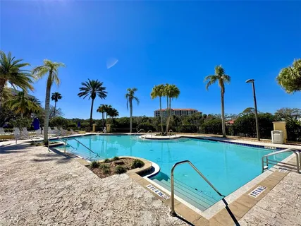 a view of a swimming pool and lounge chairs