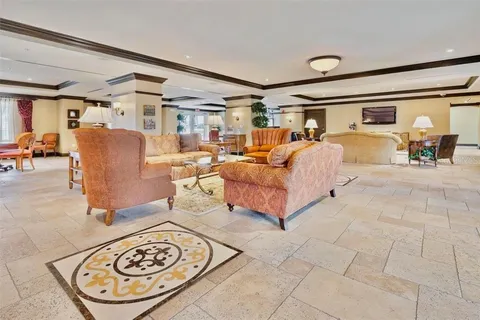 a bedroom with furniture and a large window