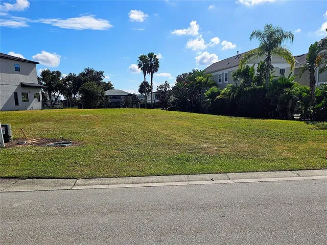 a view of a fountain in front of a house with a big yard