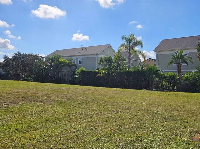 a view of a house with a yard and potted plants