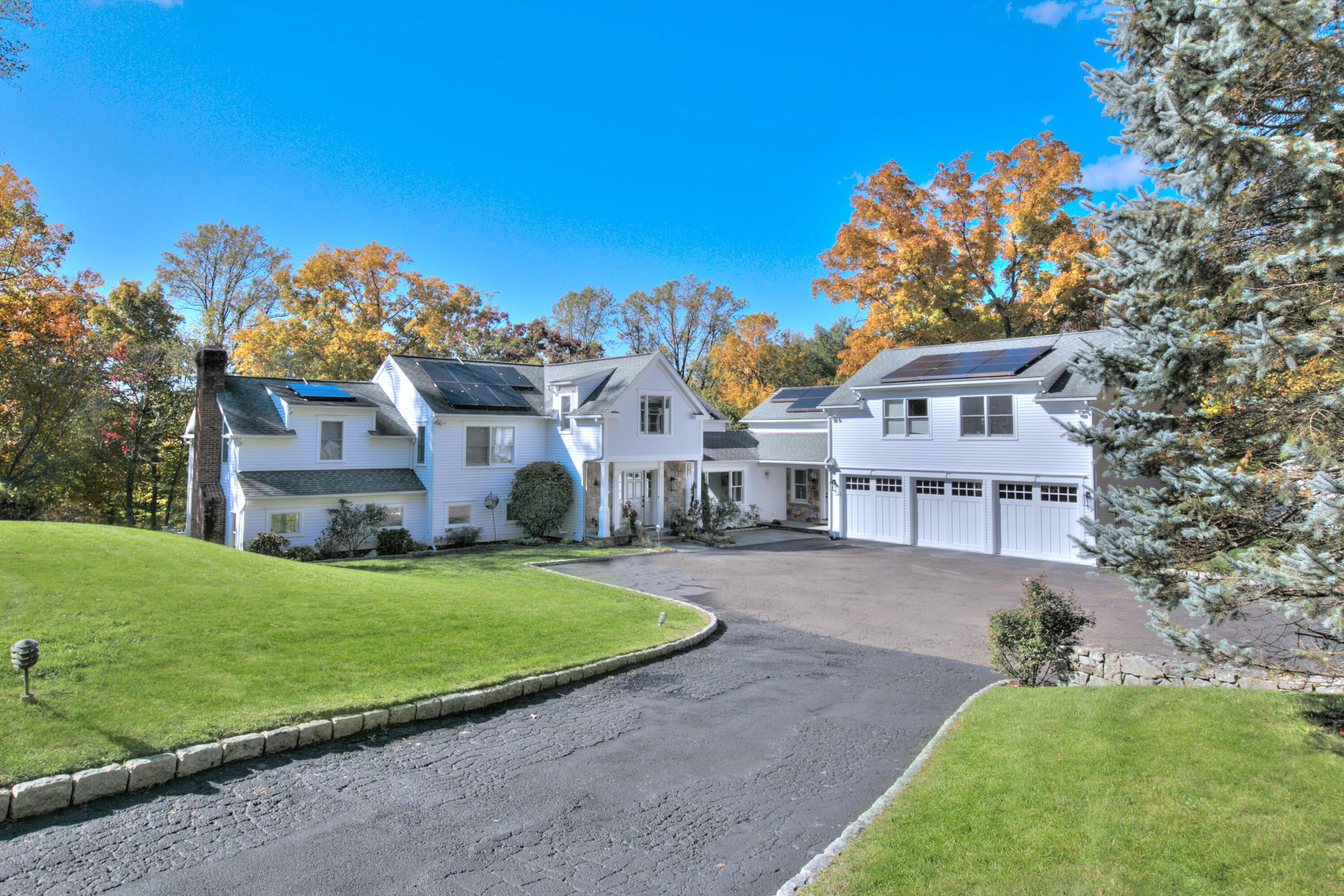 970 Ponus Ridge Road New Canaan, CT 06840 - Photo 1 of 39 a front view of a house with a garden