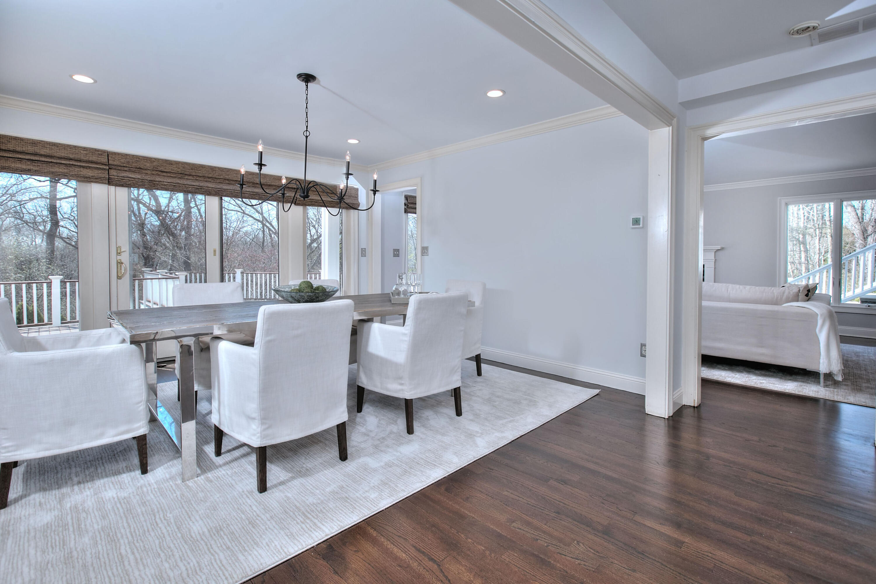 970 Ponus Ridge Road New Canaan, CT 06840 - Photo 13 of 39 a living room with furniture and a chandelier