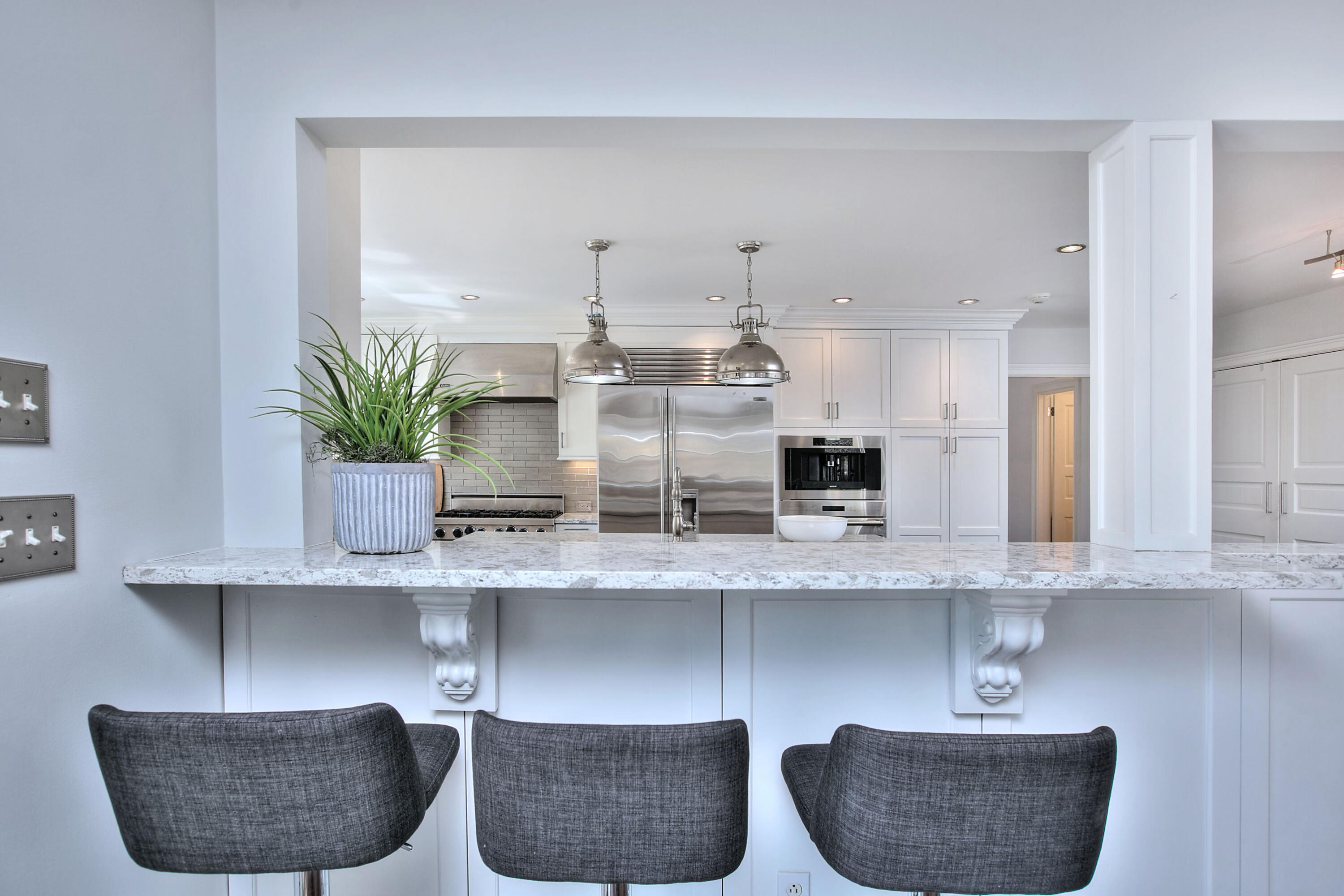 970 Ponus Ridge Road New Canaan, CT 06840 - Photo 15 of 39 a kitchen with two chair and a potted plant