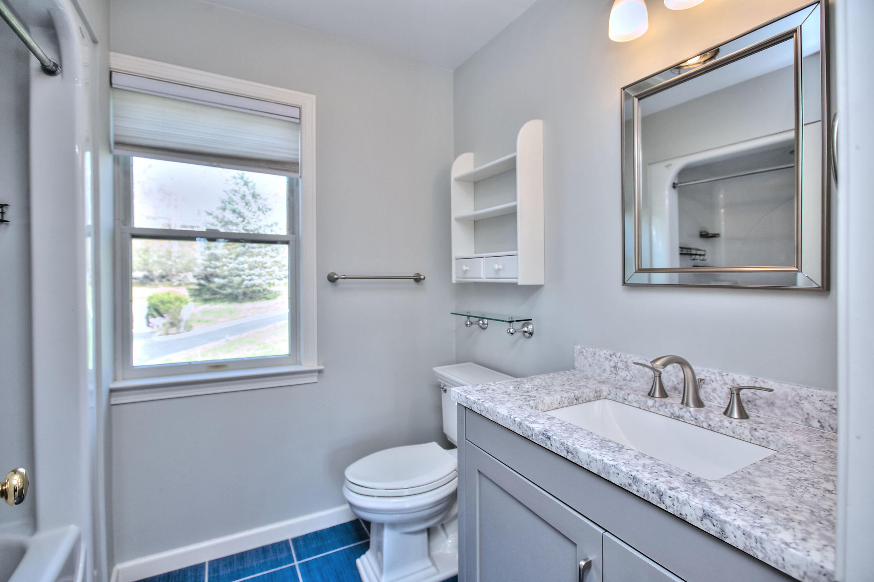 970 Ponus Ridge Road New Canaan, CT 06840 - Photo 26 of 39 a bathroom with a granite countertop toilet a sink and a mirror