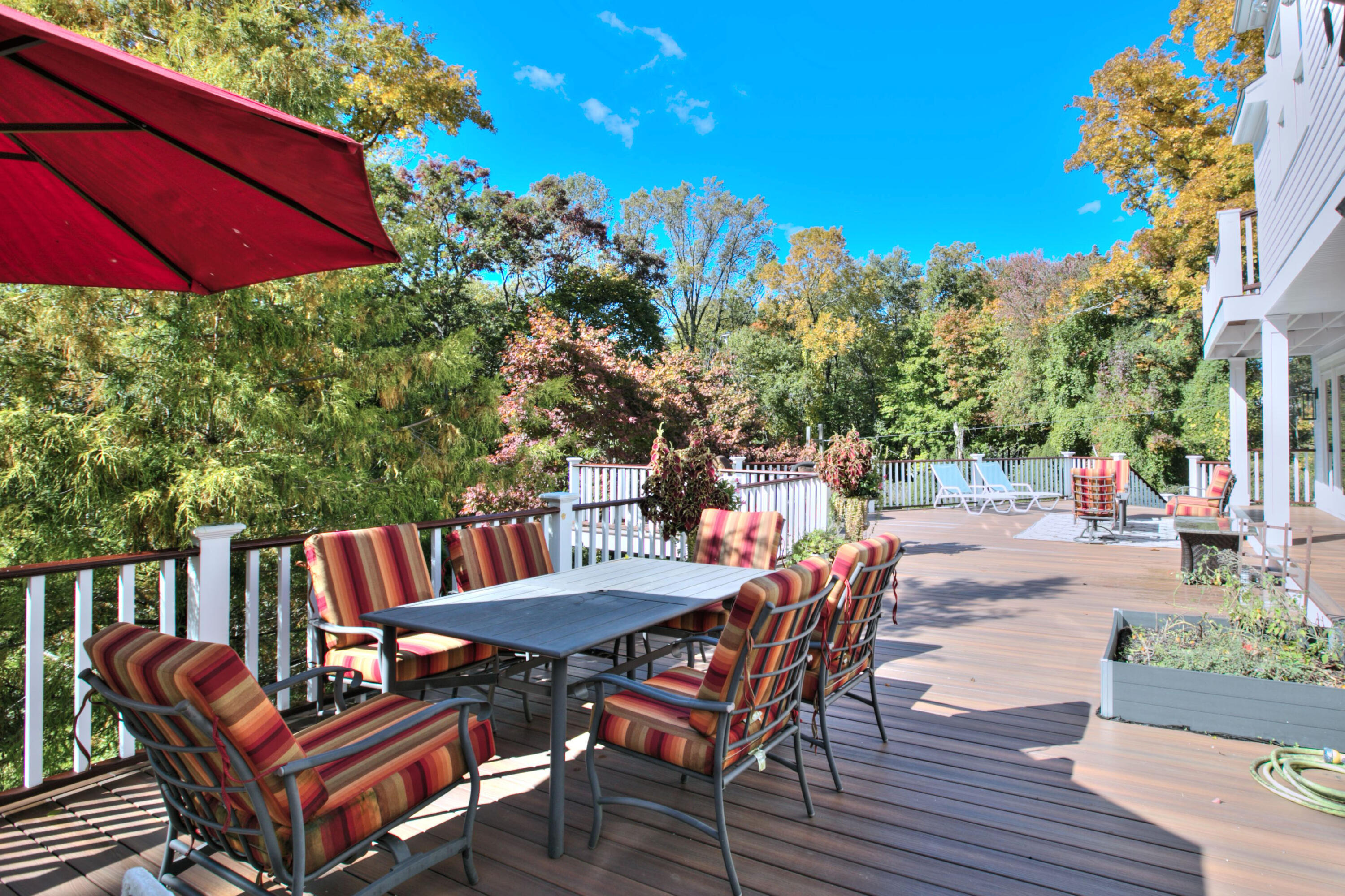 970 Ponus Ridge Road New Canaan, CT 06840 - Photo 31 of 39 a view of a patio with table and chairs potted plants with wooden floor and fence