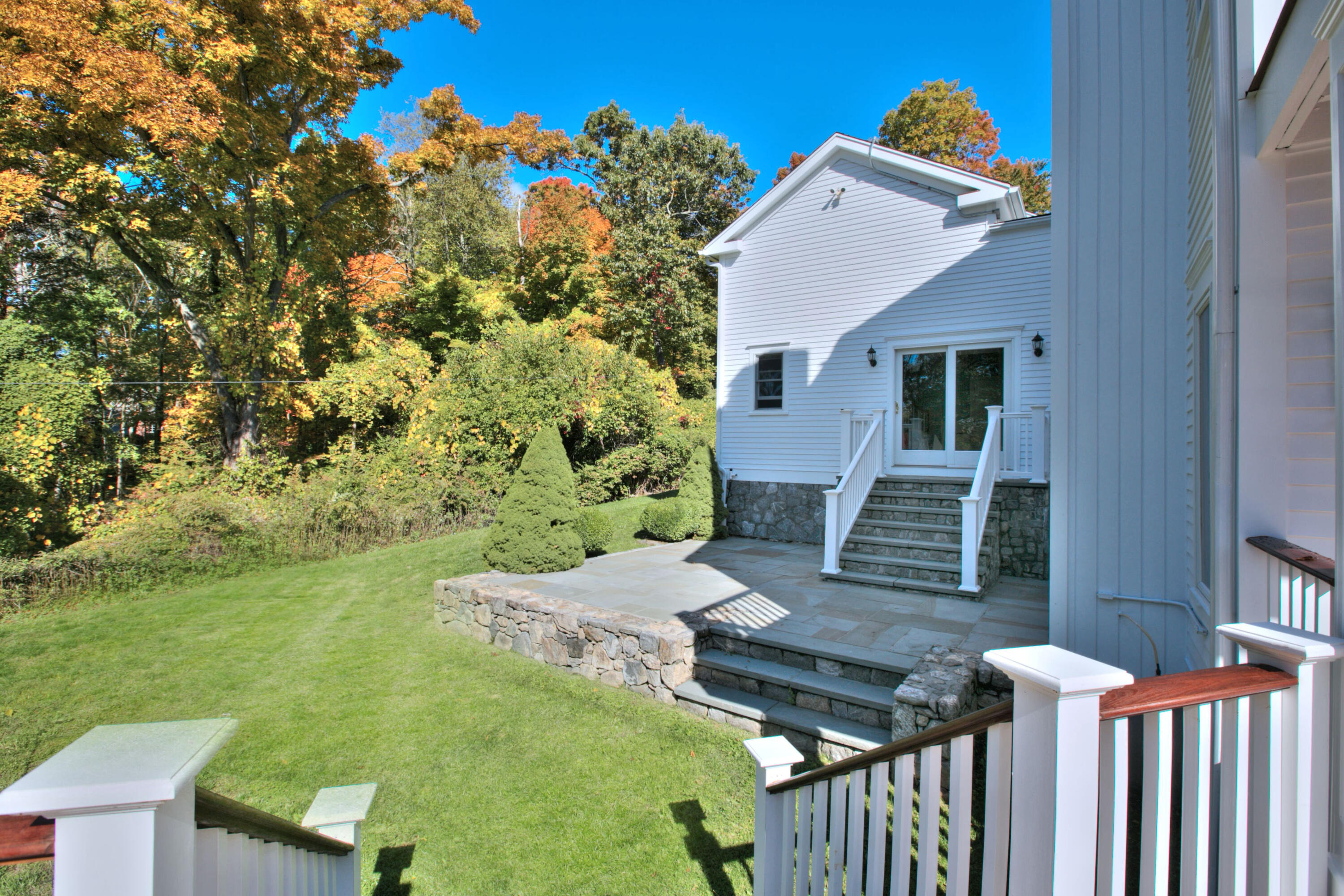 970 Ponus Ridge Road New Canaan, CT 06840 - Photo 36 of 39 a backyard of a house with table and chairs