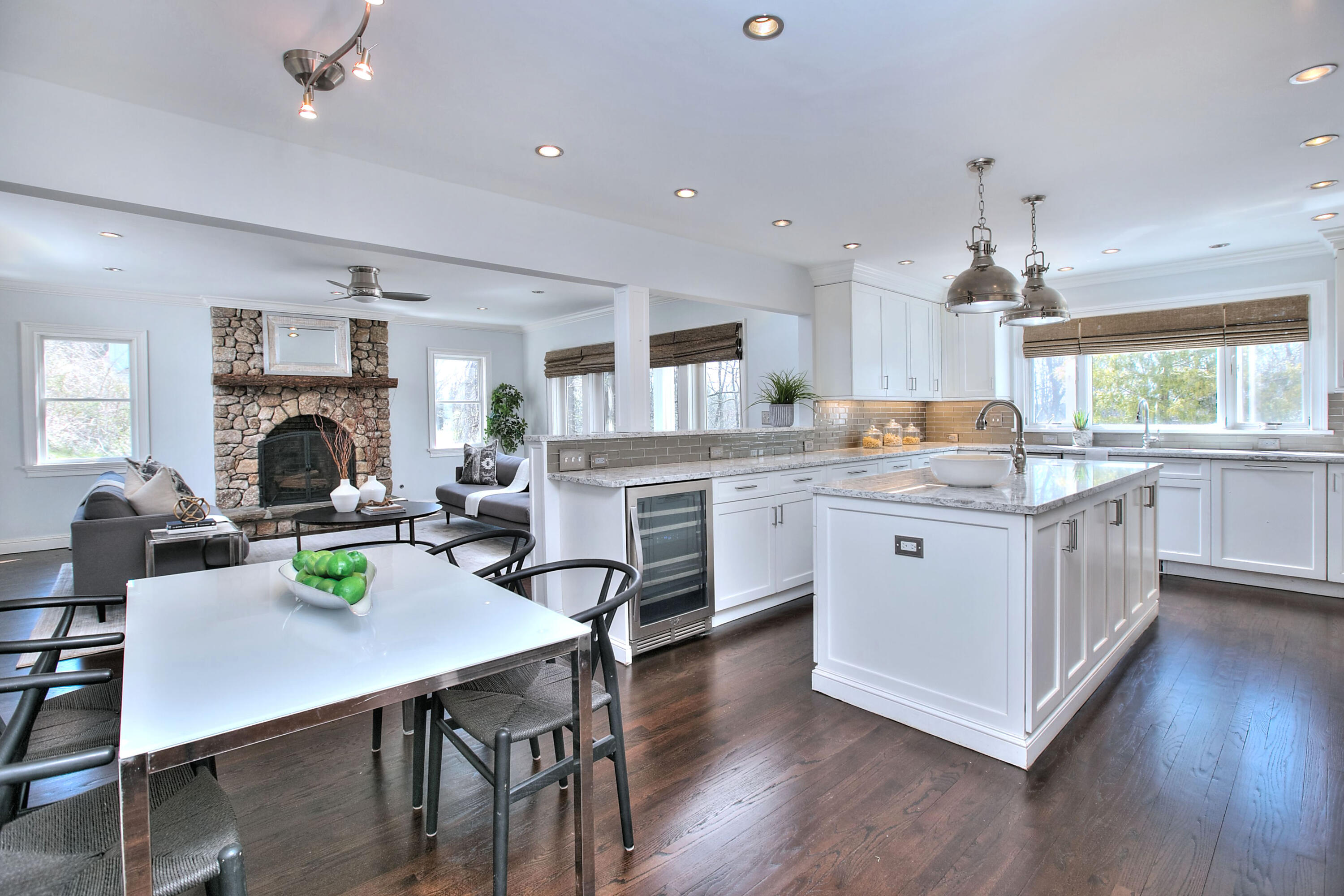 970 Ponus Ridge Road New Canaan, CT 06840 - Photo 4 of 39 a open kitchen with stainless steel appliances granite countertop a stove a sink dishwasher a dining table and chairs with wooden floor