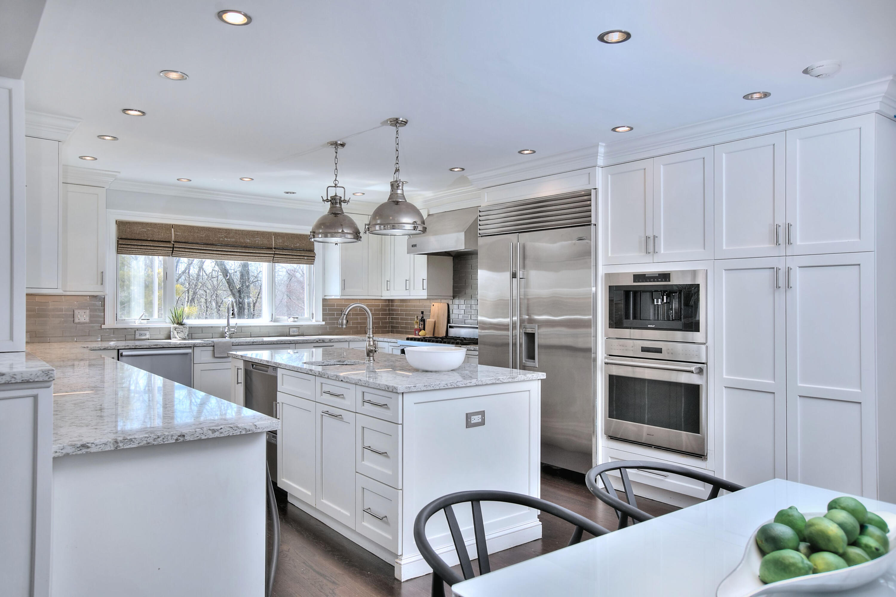 970 Ponus Ridge Road New Canaan, CT 06840 - Photo 5 of 39 a kitchen with kitchen island a stove a sink and a refrigerator