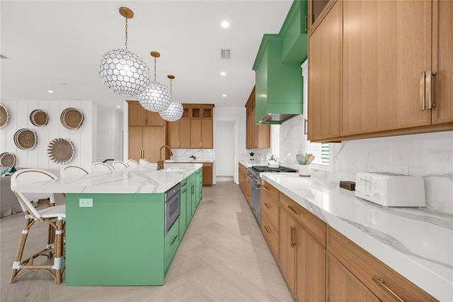 a bedroom with a bed and a flat tv screen on dresser