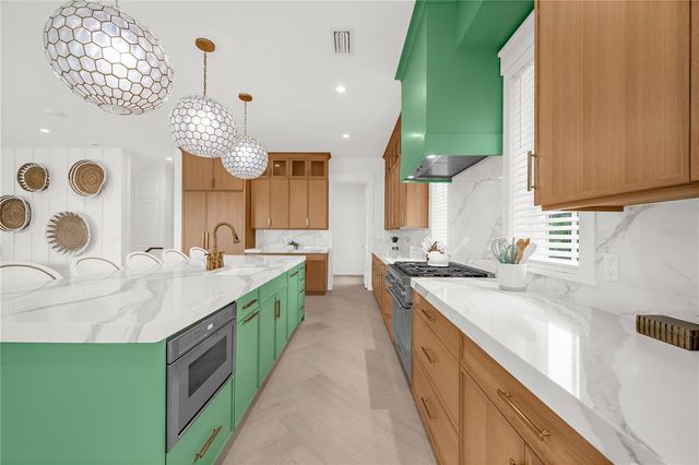 a bedroom with a large bed and a flat tv screen on dresser