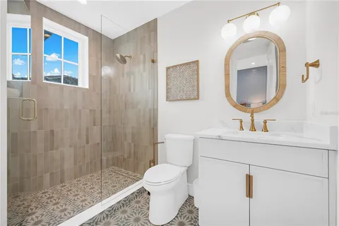 a living room with furniture a flat screen tv and a floor to ceiling window