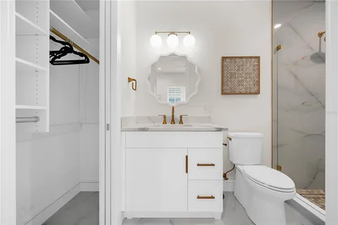 a bedroom with a bed a flat screen tv and a large window