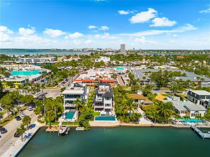a view of a dining room with furniture a chandelier and wooden floor