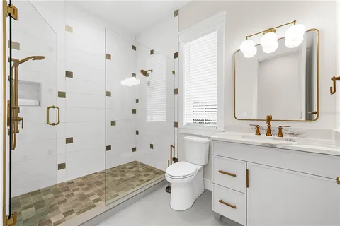 a bedroom with a bed and a flat tv screen on dresser