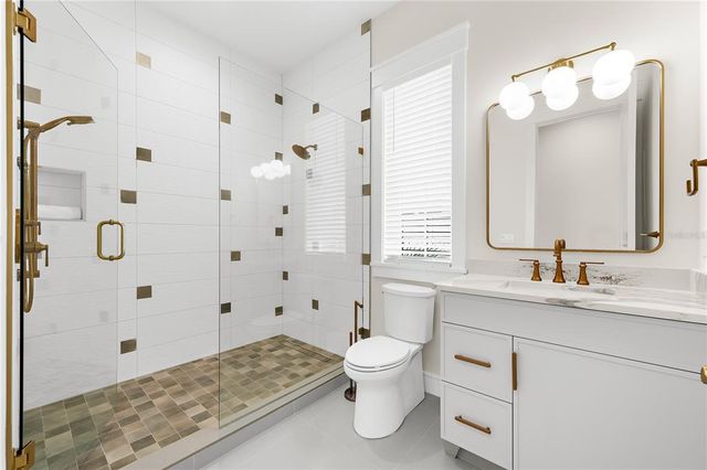 a bedroom with a bed and a flat tv screen on dresser