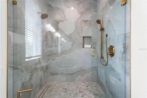 a view of a patio with a table chairs potted plants and palm trees