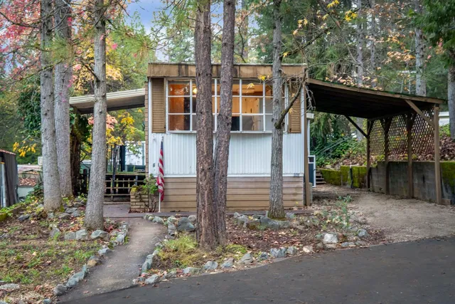 a backyard of a house with barbeque oven fire pit table and chairs