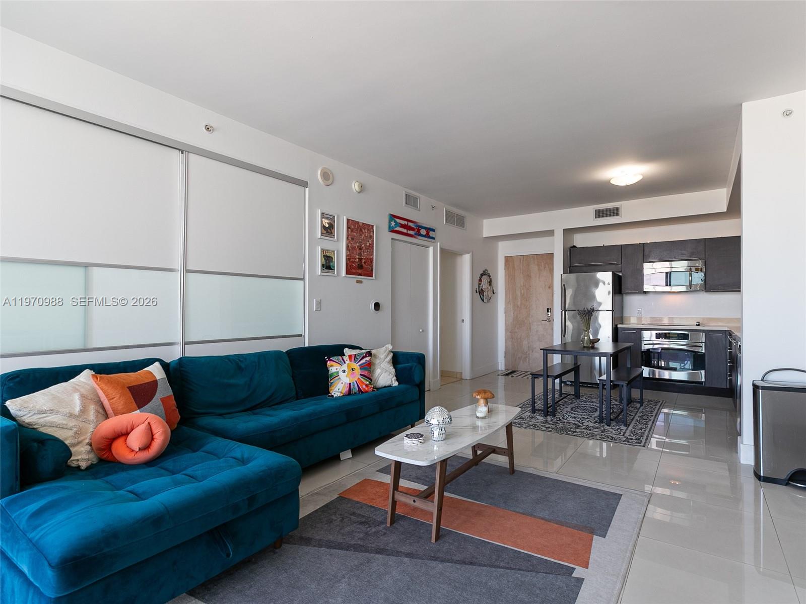 90 Southwest 3rd Street, Unit 1611 Miami, FL 33130 - Photo 11 of 44 a living room with furniture and wooden floor
