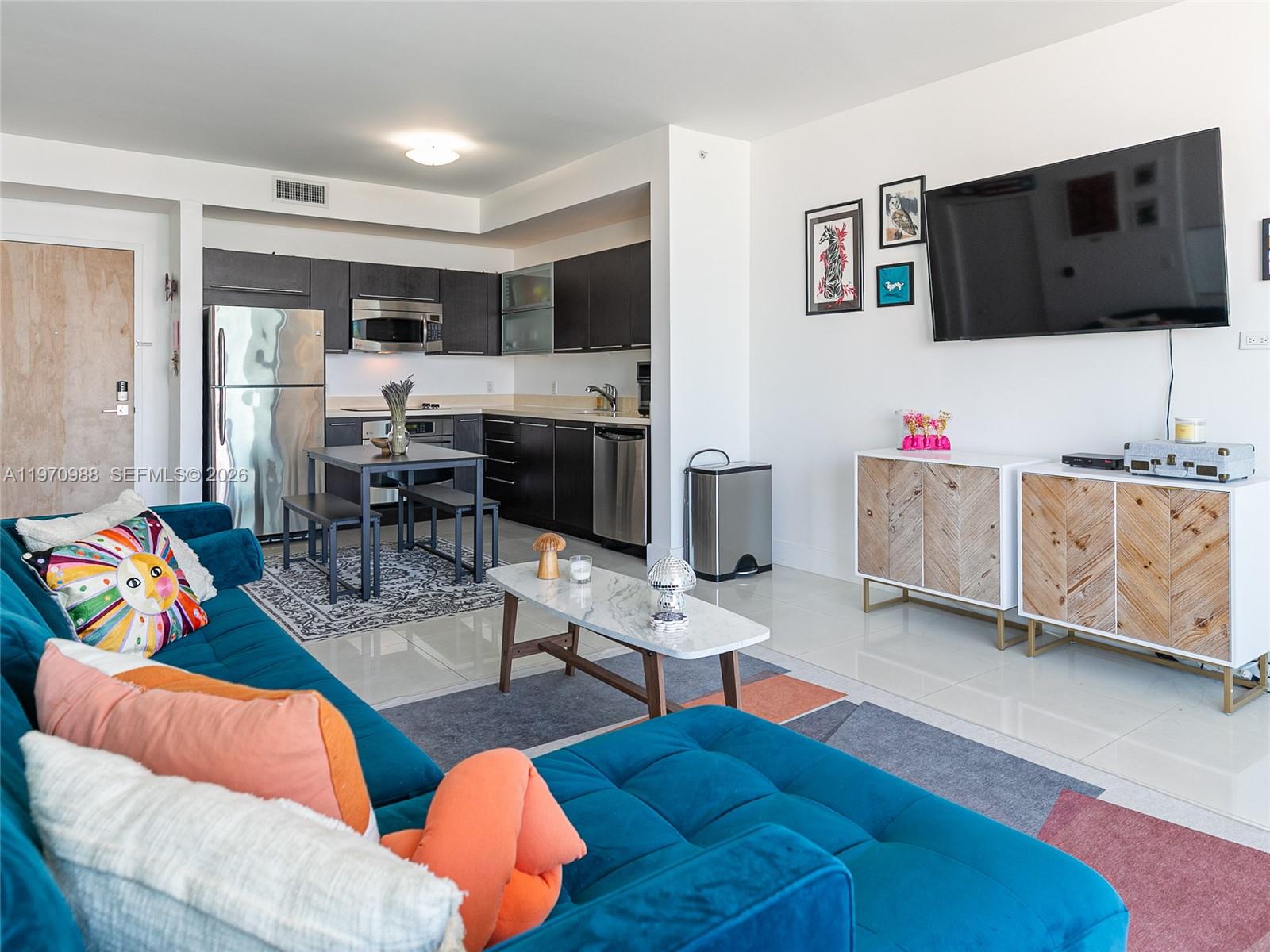 90 Southwest 3rd Street, Unit 1611 Miami, FL 33130 - Photo 12 of 44 a living room with furniture and a flat screen tv