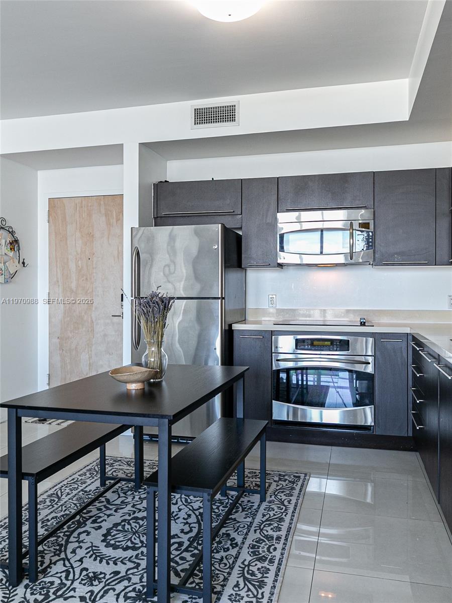 90 Southwest 3rd Street, Unit 1611 Miami, FL 33130 - Photo 13 of 44 a kitchen with a stove and a refrigerator