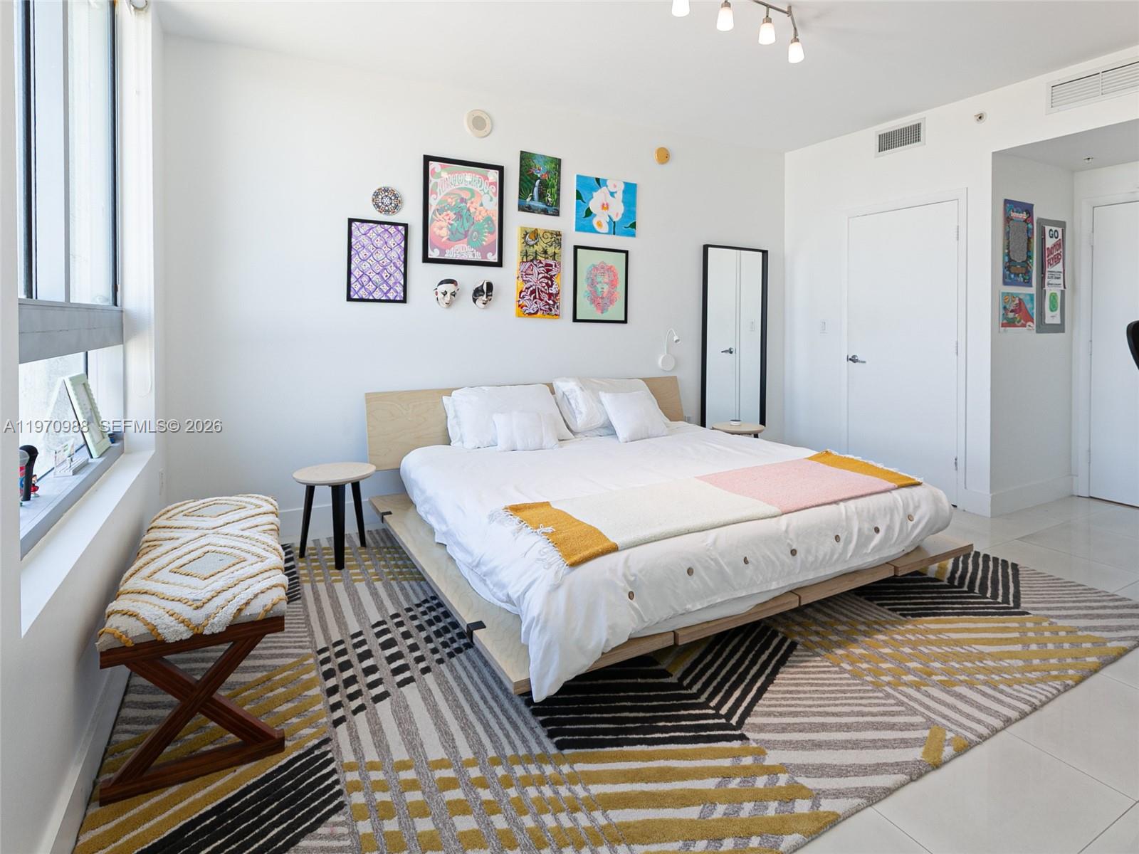 90 Southwest 3rd Street, Unit 1611 Miami, FL 33130 - Photo 15 of 44 a bedroom with a bed and wooden floor