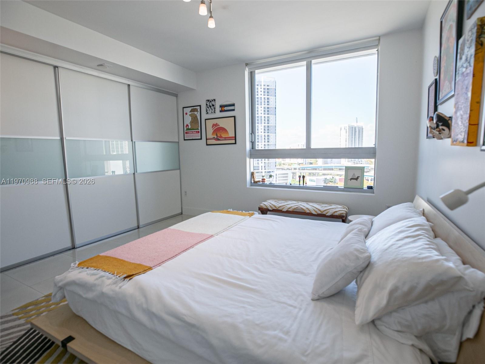 90 Southwest 3rd Street, Unit 1611 Miami, FL 33130 - Photo 16 of 44 a bedroom with a bed and a window