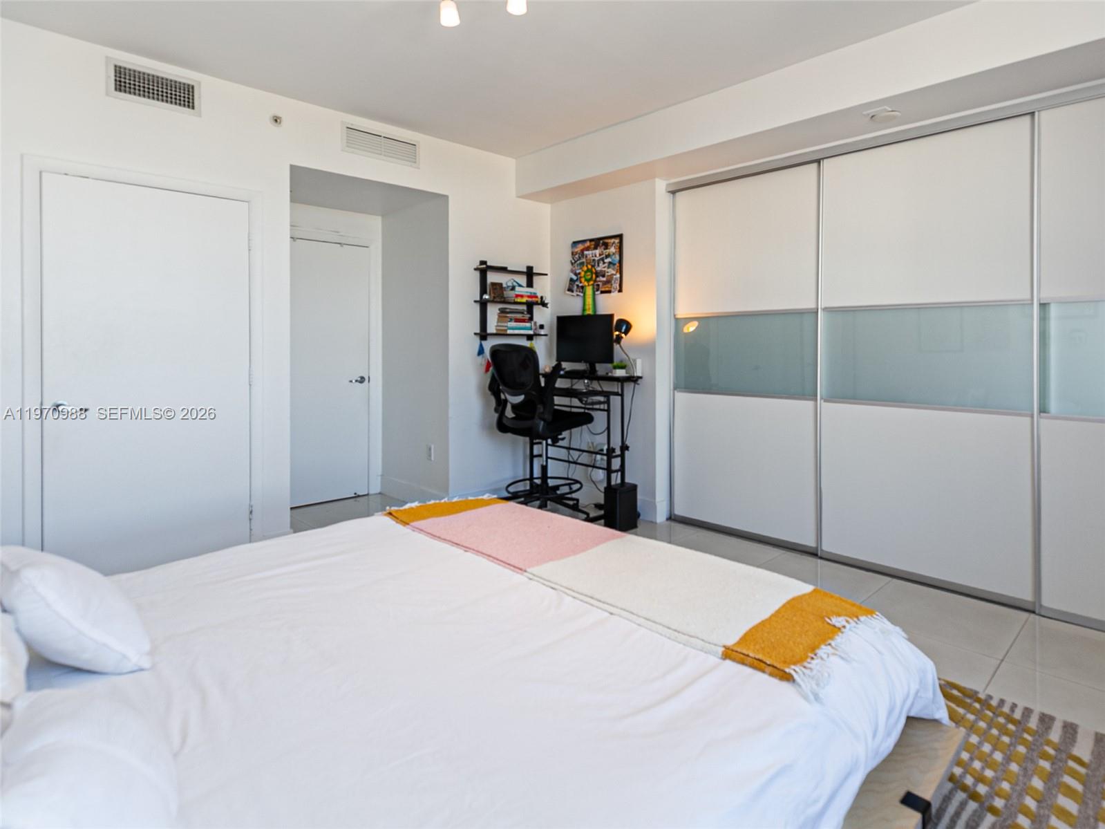 90 Southwest 3rd Street, Unit 1611 Miami, FL 33130 - Photo 17 of 44 a bedroom with a bed and a dresser