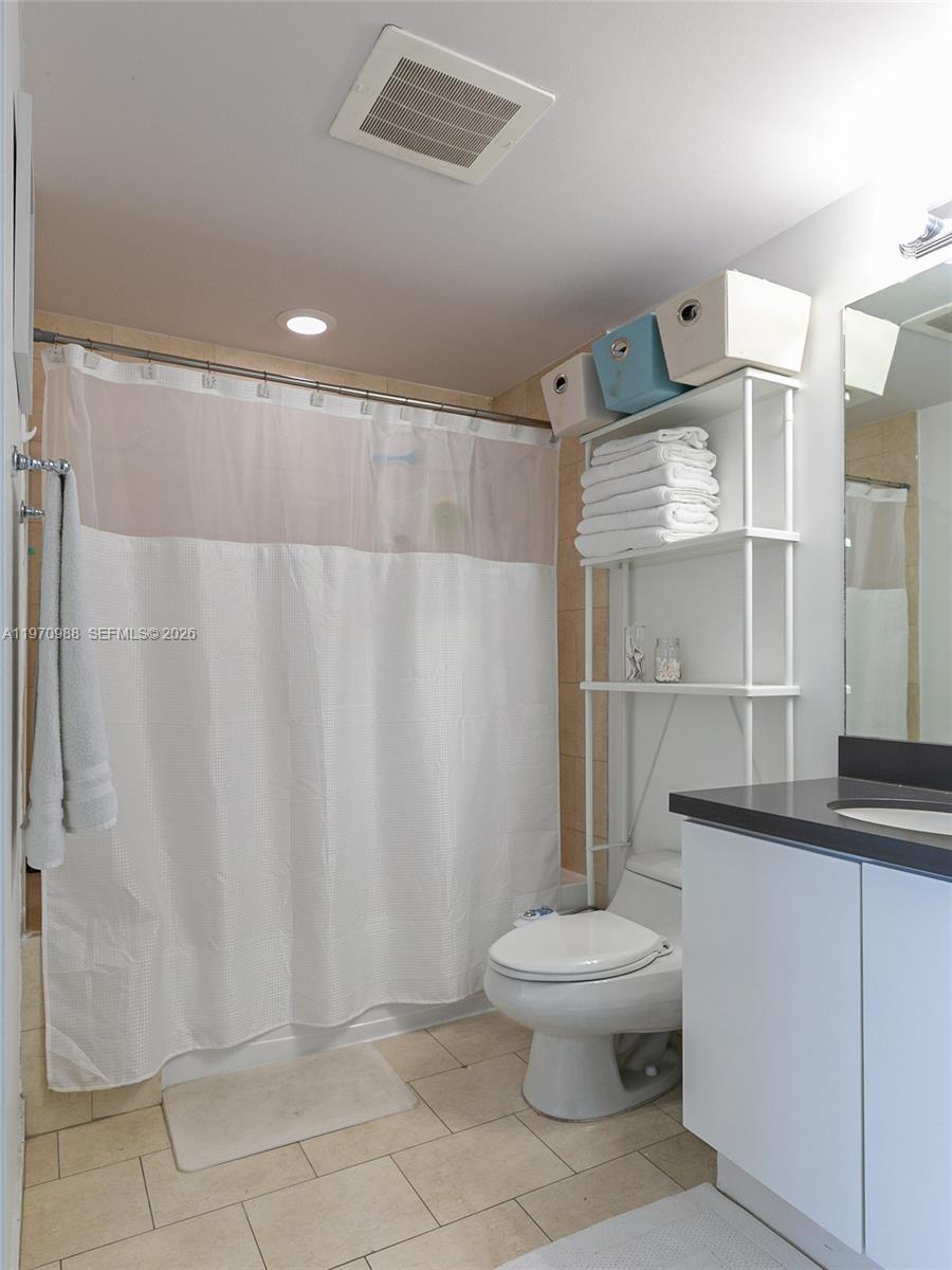 90 Southwest 3rd Street, Unit 1611 Miami, FL 33130 - Photo 19 of 44 a bathroom with a toilet a sink and shower