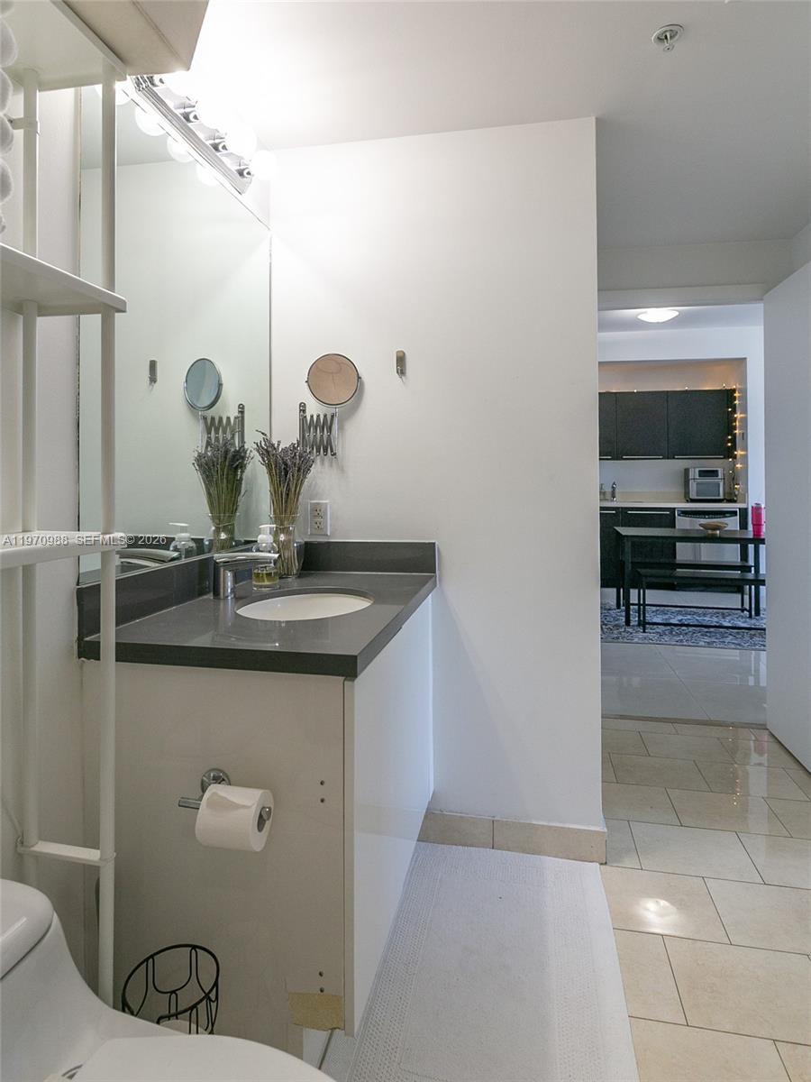 90 Southwest 3rd Street, Unit 1611 Miami, FL 33130 - Photo 20 of 44 a bathroom with a sink and a mirror