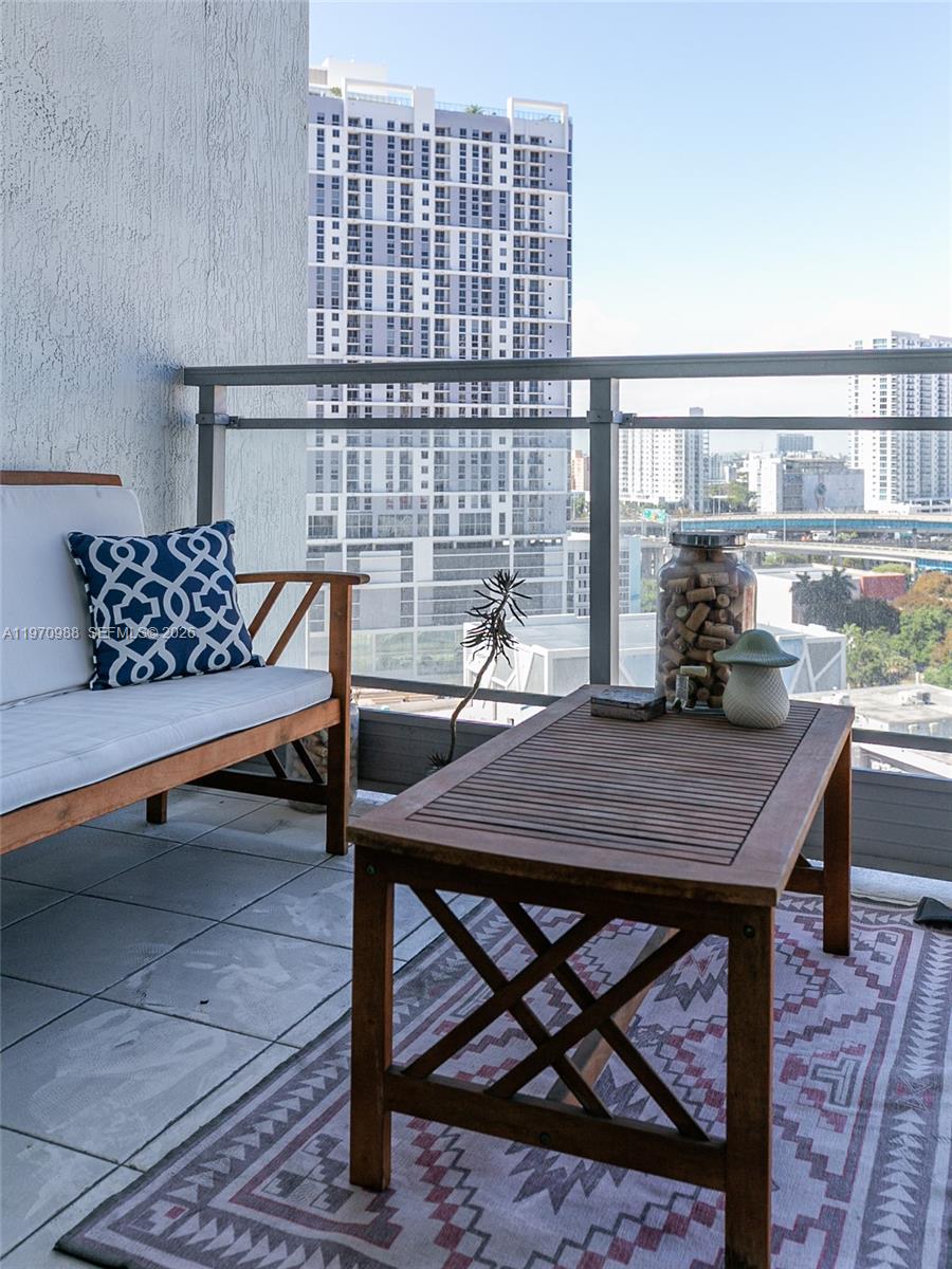 90 Southwest 3rd Street, Unit 1611 Miami, FL 33130 - Photo 21 of 44 a roof deck with table and chairs