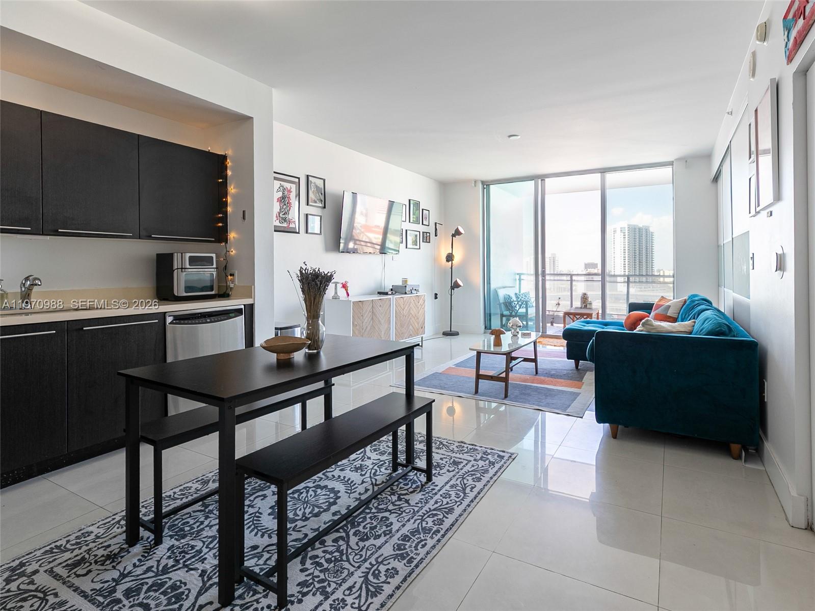 90 Southwest 3rd Street, Unit 1611 Miami, FL 33130 - Photo 8 of 44 a living room with furniture and a flat screen tv