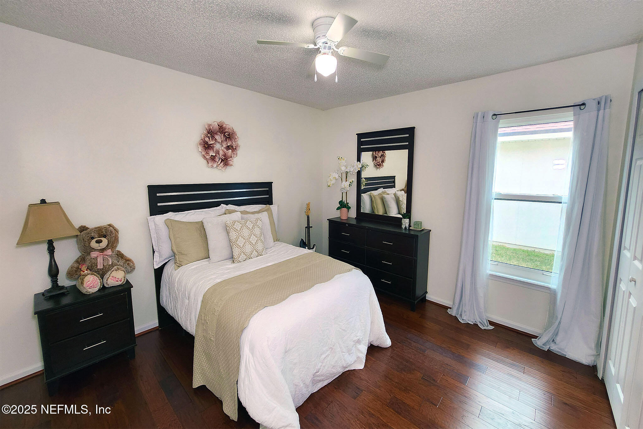 6257 Duclay Road Jacksonville, FL 32244 - Photo 11 of 21 a bedroom with a bed and a chandelier