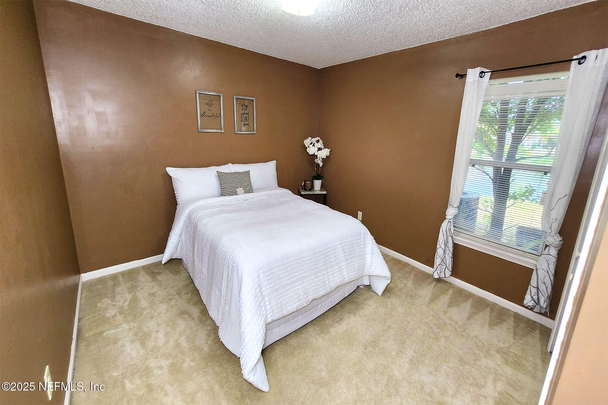 6257 Duclay Road Jacksonville, FL 32244 - Photo 13 of 21 a bedroom with a bed and a large window