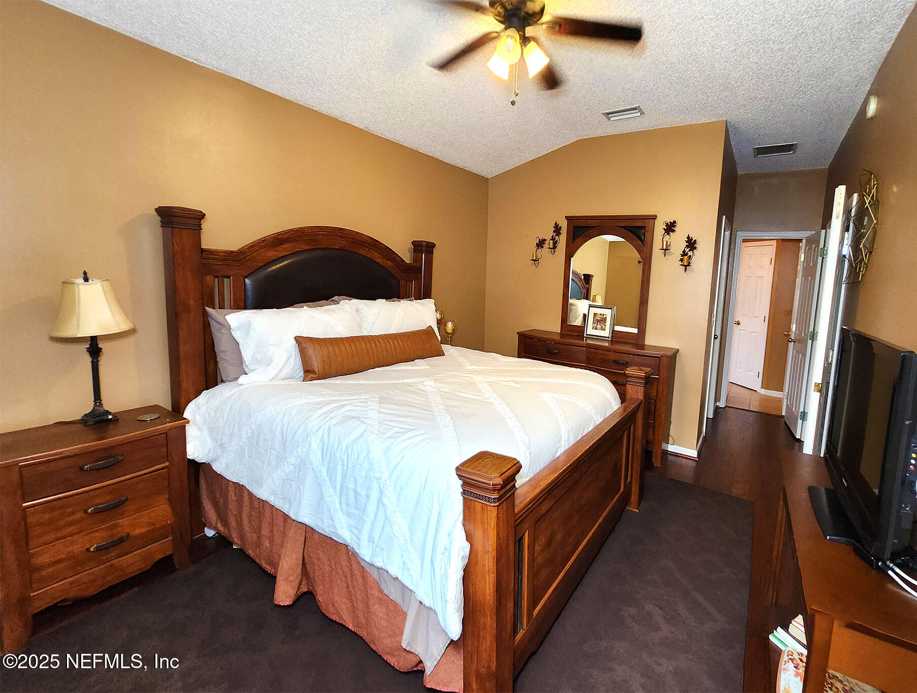 6257 Duclay Road Jacksonville, FL 32244 - Photo 17 of 21 a bedroom with a bed and a chandelier