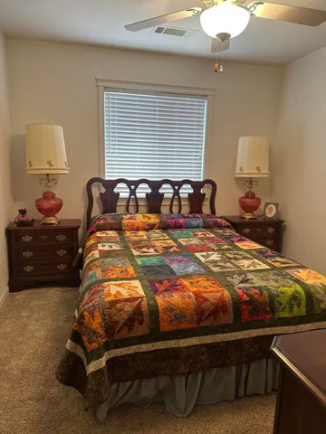 a bed sitting in a bedroom next to a window