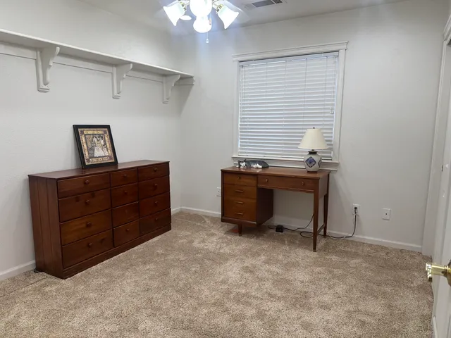 a room that has a dresser and a window
