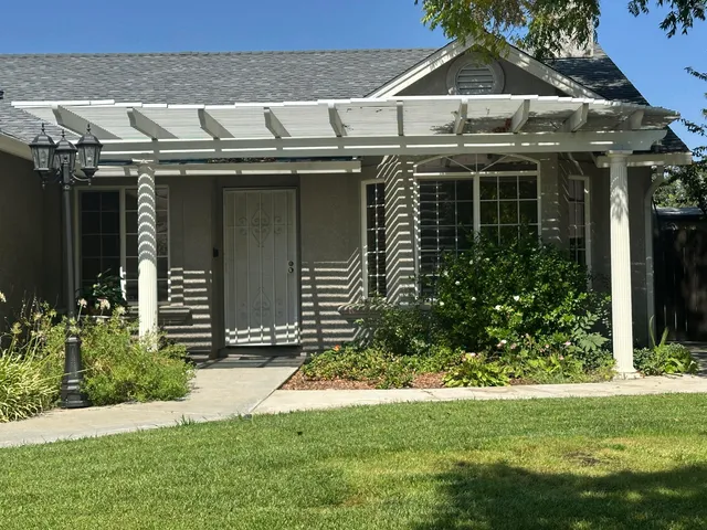 a front view of a house with garden