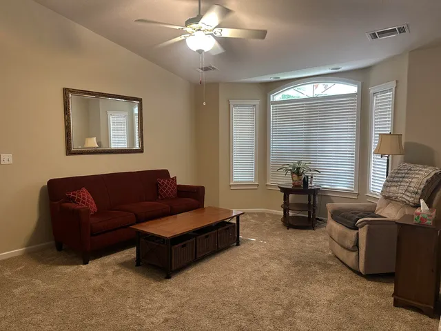 a living room with furniture and a large window