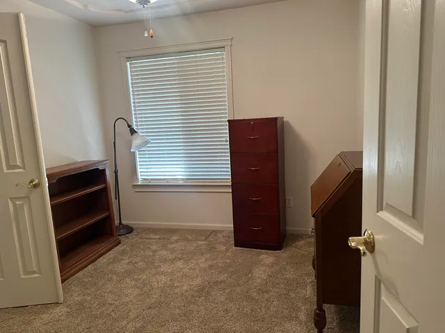 a view of an empty room with a fireplace