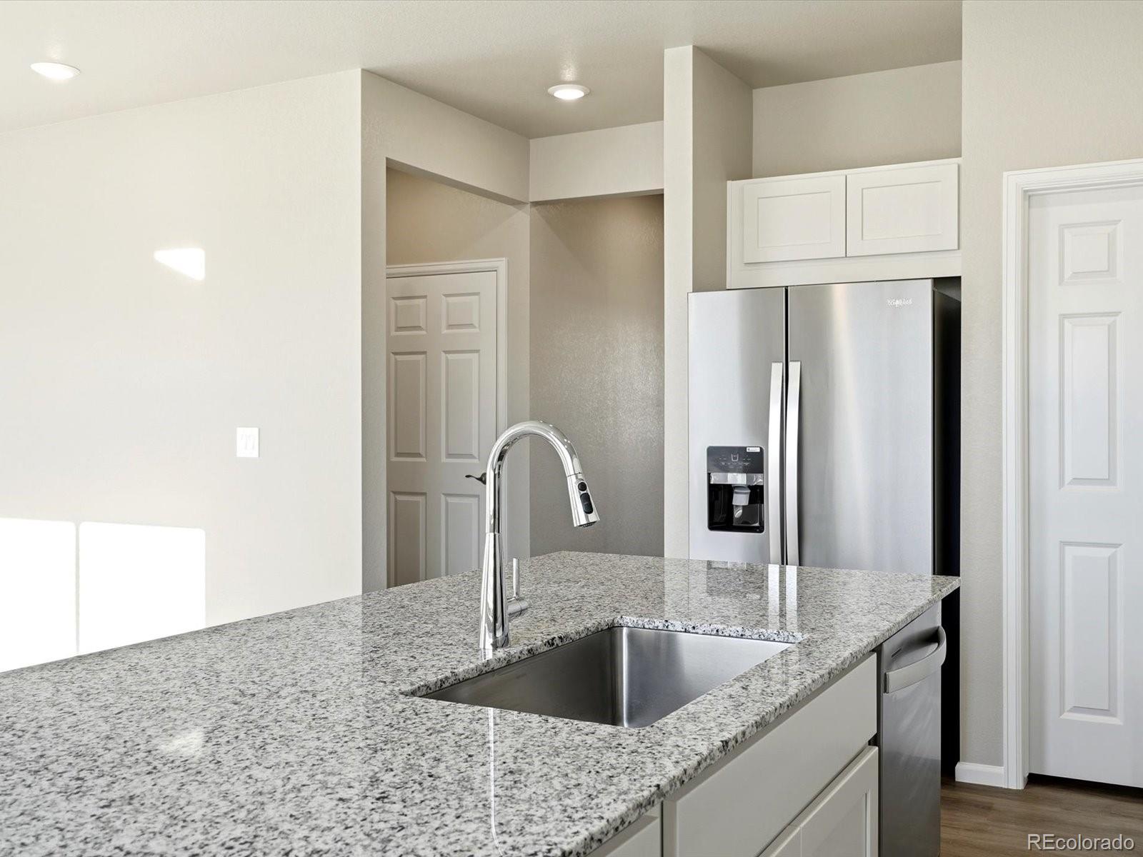 7317 West 27th St Road Greeley, CO 80634 - Photo 10 of 28 a kitchen with stainless steel appliances granite countertop a refrigerator and a sink