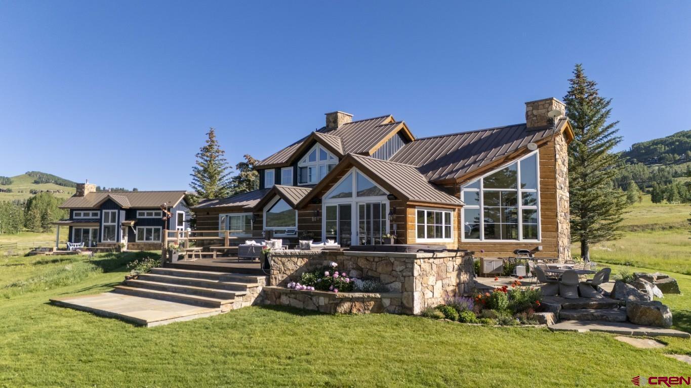 a front view of a house with a yard table and chairs