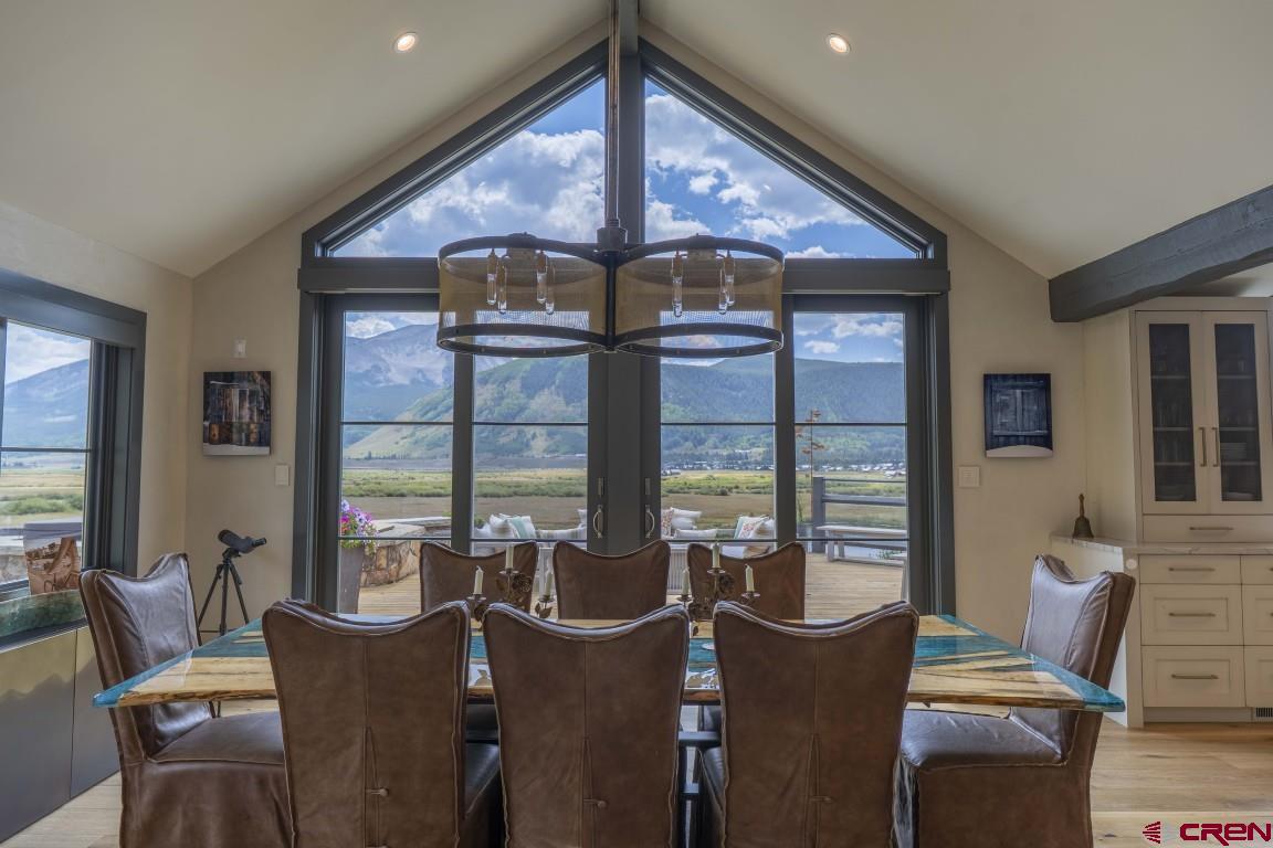 7 Moon Ridge Lane Crested Butte, CO 81224 - Photo 17 of 44 a dining room with furniture large windows and a chandelier