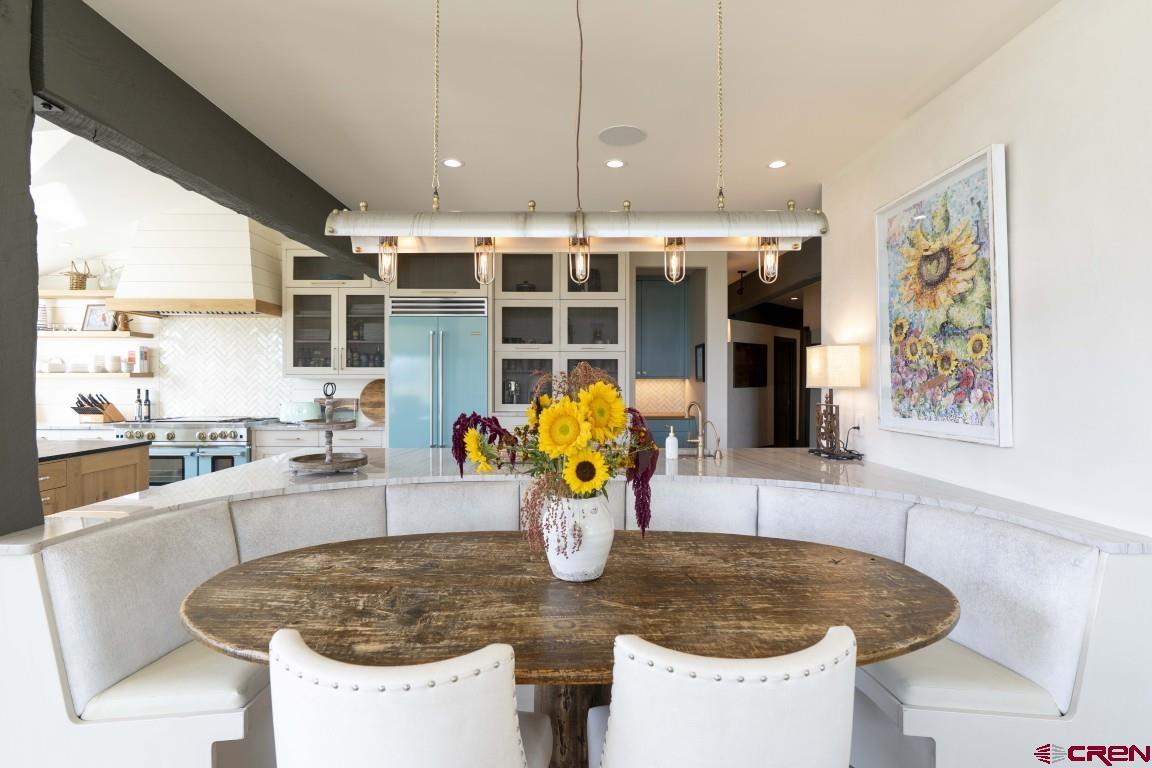 7 Moon Ridge Lane Crested Butte, CO 81224 - Photo 24 of 44 a dining table with chairs and potted plant