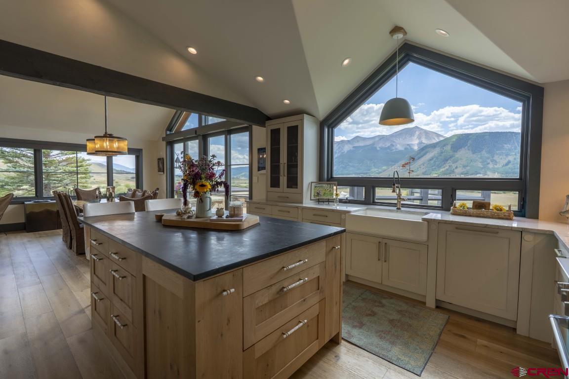 7 Moon Ridge Lane Crested Butte, CO 81224 - Photo 28 of 44 a kitchen with stainless steel appliances granite countertop a sink a stove and a wooden floors