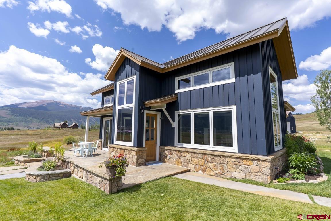 7 Moon Ridge Lane Crested Butte, CO 81224 - Photo 32 of 44 a view of a house with a patio and a yard