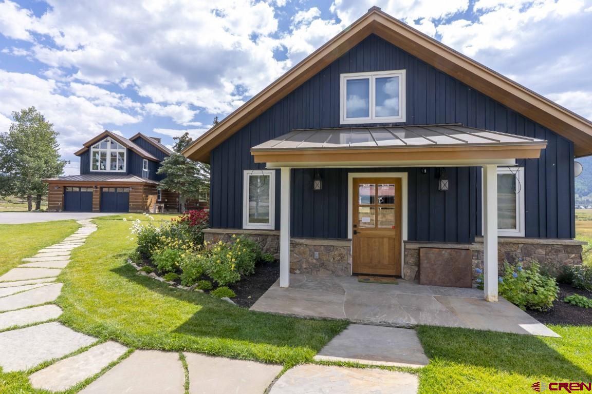 7 Moon Ridge Lane Crested Butte, CO 81224 - Photo 33 of 44 a front view of a house with a yard