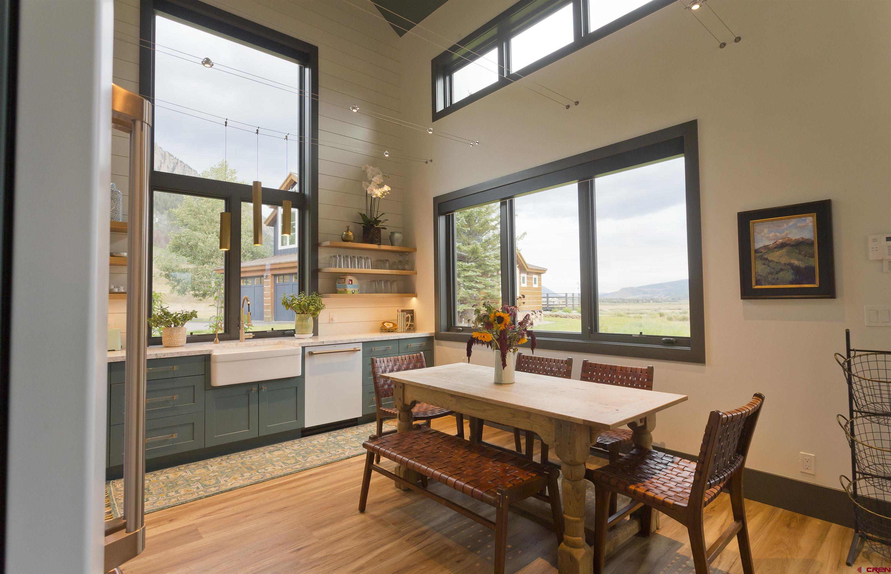 7 Moon Ridge Lane Crested Butte, CO 81224 - Photo 36 of 44 a dining room with furniture a chandelier and wooden floor