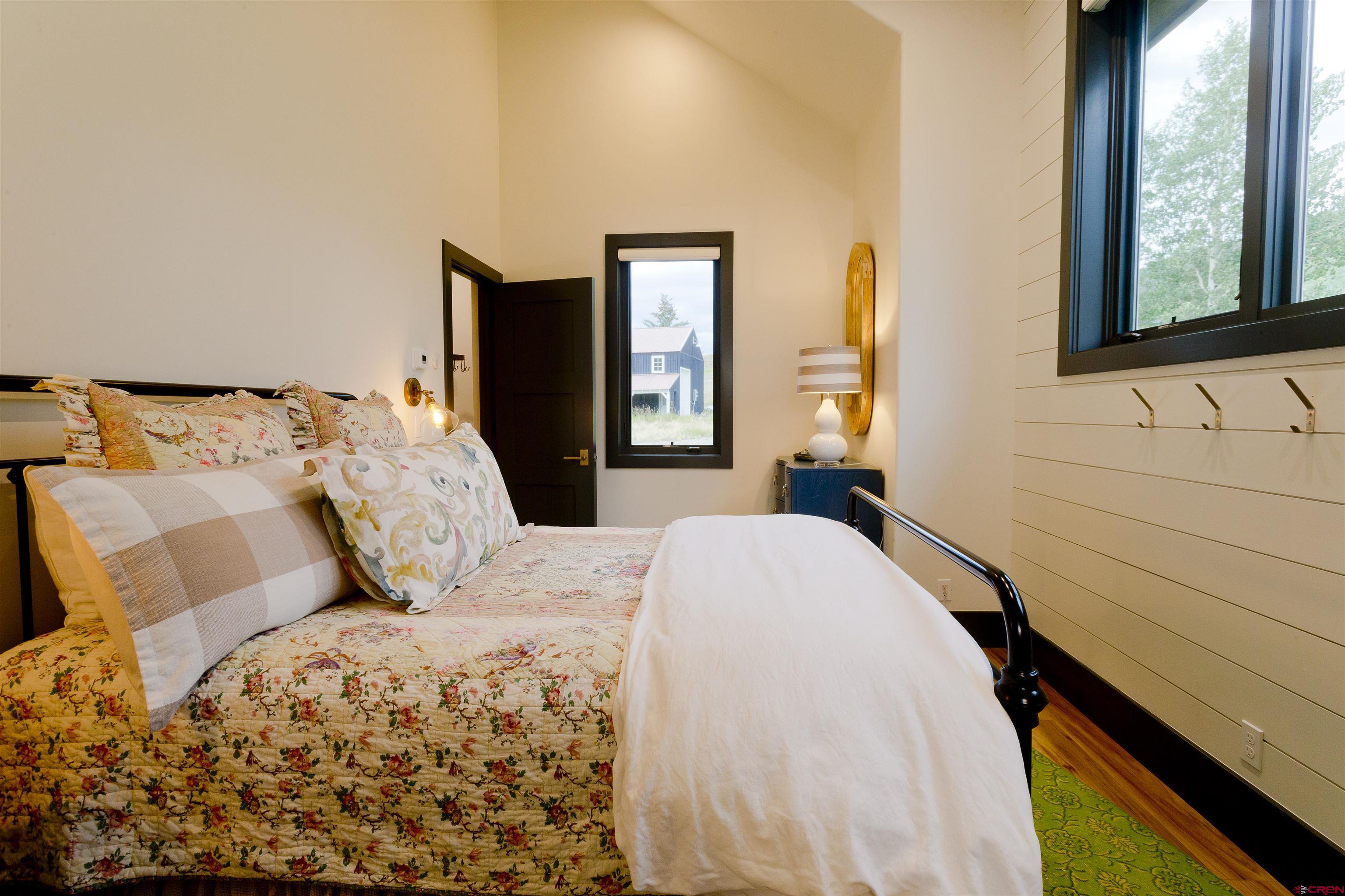 7 Moon Ridge Lane Crested Butte, CO 81224 - Photo 37 of 44 a bedroom with a large bed and a window