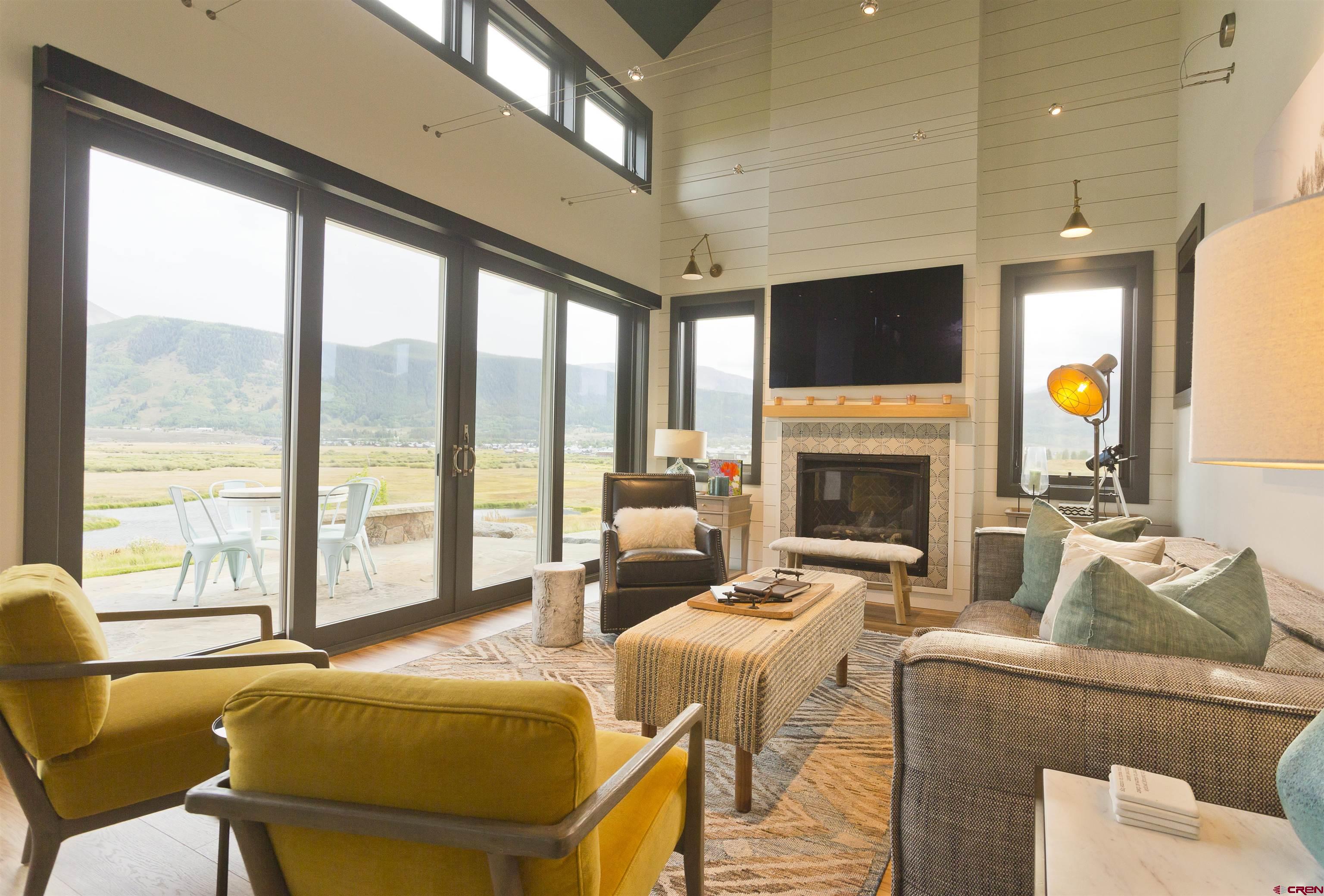 7 Moon Ridge Lane Crested Butte, CO 81224 - Photo 41 of 44 a living room with a fireplace and a floor to ceiling window