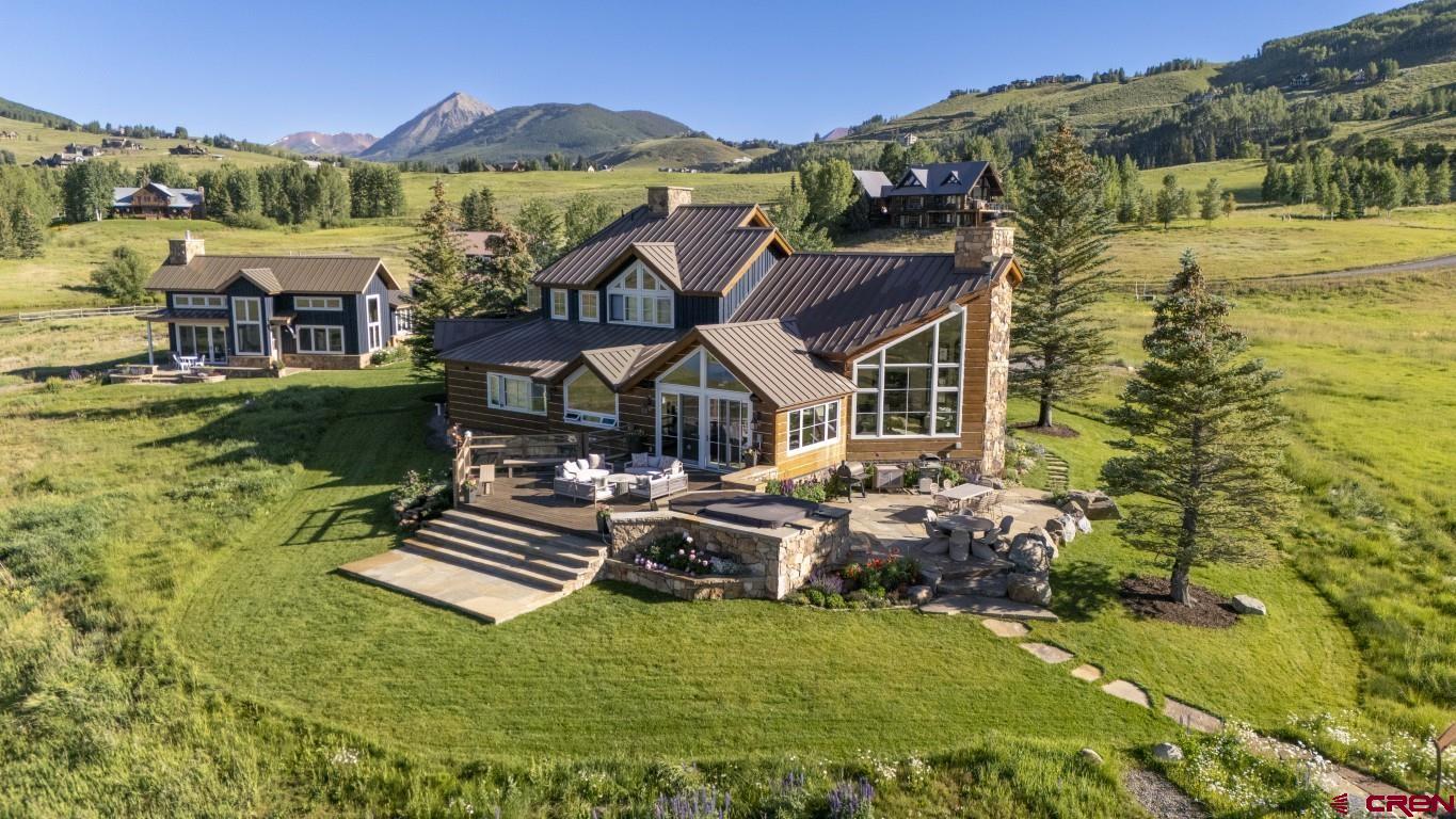 7 Moon Ridge Lane Crested Butte, CO 81224 - Photo 6 of 44 a aerial view of a house with swimming pool garden and lake view